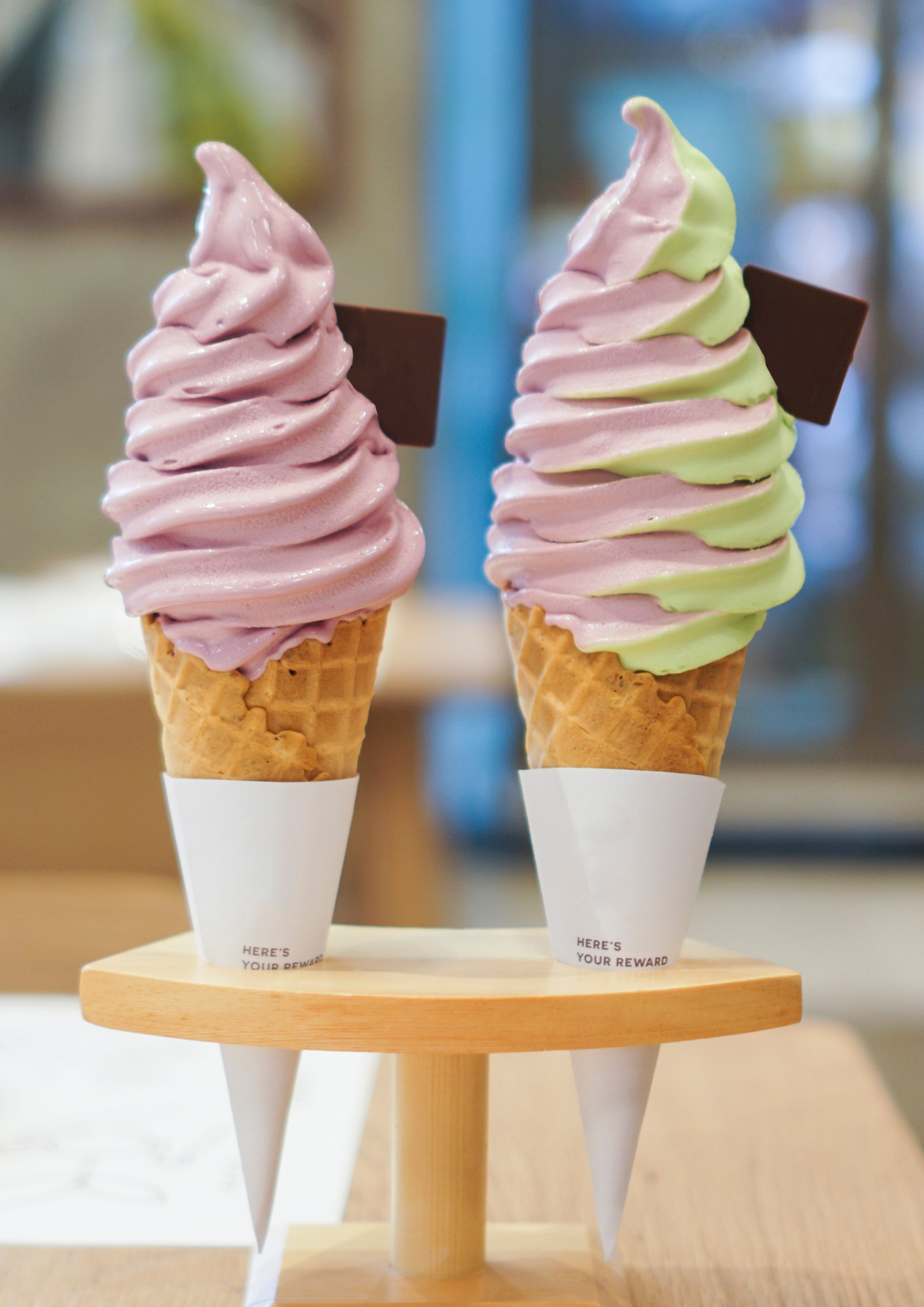 Two soft serve ice creams in waffle cones